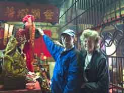 Tim and Jane touching pig god's head