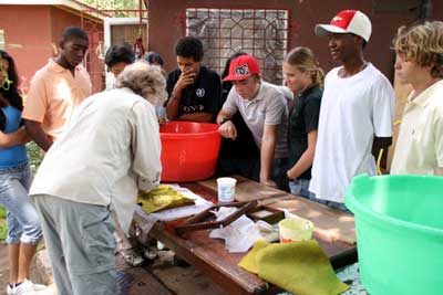 Jane teaching the students how to make paper