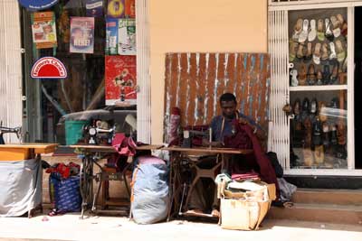 Moshi street seen with tailor at his pedal sewing machine