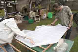 Jane and Seppo fitting mesh on large screen