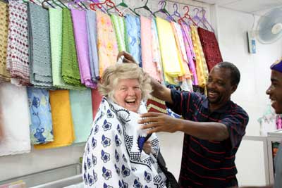 Pelli draping traditional fabric around Jane